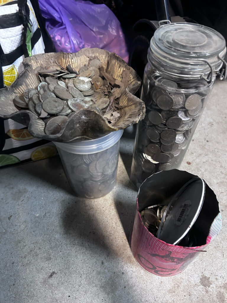 Containers of old Australian loose change before sorting